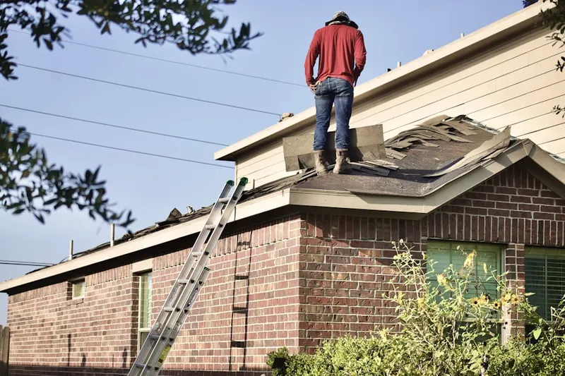 Professional roofer working on a residential roof in Crooked Creek at Oaks